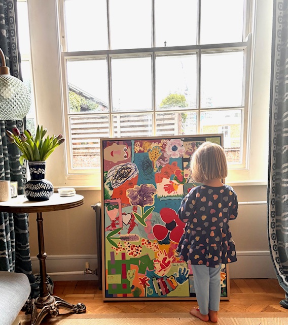 Child standing in front of her bespoke Littlest Galleries framed artwork